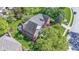 An aerial perspective of a brick house featuring a gray roof, lovely landscaping and surrounding greenery at 14215 Stacey St, Carmel, IN 46033