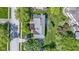 Overhead view of home with manicured lawn, mature trees, a driveway, and patio with outdoor seating at 14215 Stacey St, Carmel, IN 46033