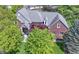 Stunning aerial view of a red brick home with a lush green lawn and mature trees adding curb appeal at 14215 Stacey St, Carmel, IN 46033