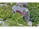 Overhead view of the brick home showcasing its manicured lawn, mature trees and architectural details at 14215 Stacey St, Carmel, IN 46033