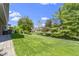 Expansive backyard with lush green lawn, mature trees, and paver patio at 14215 Stacey St, Carmel, IN 46033
