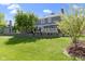 Professionally landscaped backyard with a large grassy area and outdoor patio at 14215 Stacey St, Carmel, IN 46033