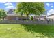Landscaped backyard includes a grassy area, retaining wall, and elevated outdoor patio at 14215 Stacey St, Carmel, IN 46033