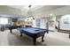 Open basement with pool table, foosball table, and classic car decor at 14215 Stacey St, Carmel, IN 46033