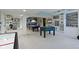 Finished basement showcasing a pool table, air hockey, foosball, and car-themed décor at 14215 Stacey St, Carmel, IN 46033