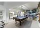 Finished basement with pool table, bar seating, and unique automotive decor at 14215 Stacey St, Carmel, IN 46033