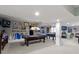 Spacious finished basement featuring a pool table, foosball, and vintage-themed décor at 14215 Stacey St, Carmel, IN 46033