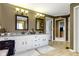 Double sink bathroom features granite countertops, a soaking tub, and wooden-style flooring at 14215 Stacey St, Carmel, IN 46033