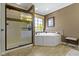 Stylish bathroom features a soaking tub and a separate glass-enclosed shower at 14215 Stacey St, Carmel, IN 46033