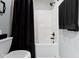 Bathroom featuring shower/tub combination with black shower curtain and neutral walls at 14215 Stacey St, Carmel, IN 46033