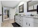 Bright bathroom with double granite vanity, wood-look tile, and neutral color scheme at 14215 Stacey St, Carmel, IN 46033