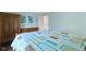 A spacious bedroom is brightened by light blue walls and has unique, colorful, geometric patterns at 14215 Stacey St, Carmel, IN 46033