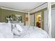 Charming bedroom with a four-poster bed, decorative artwork, and en-suite bathroom access at 14215 Stacey St, Carmel, IN 46033