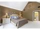This cozy bedroom features neutral-toned walls and carpet, high ceilings, and traditional decor at 14215 Stacey St, Carmel, IN 46033
