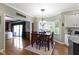 Open dining room space with a bay window, classic decor, and access to the kitchen at 14215 Stacey St, Carmel, IN 46033