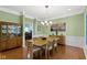 Formal dining room featuring hardwood floors, elegant chandelier, and classic wainscoting at 14215 Stacey St, Carmel, IN 46033