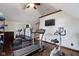 Well-equipped exercise room with various machines, including a treadmill and elliptical, for a complete workout at 14215 Stacey St, Carmel, IN 46033