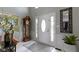 Bright foyer with a grand front door, wainscotting and a view to the staircase at 14215 Stacey St, Carmel, IN 46033