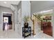 Inviting foyer with a beautiful floral arrangement and staircase leading to the upper level at 14215 Stacey St, Carmel, IN 46033