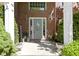 Charming front porch with brick columns, plants, decor and a welcoming front door at 14215 Stacey St, Carmel, IN 46033