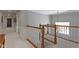 Open hallway features wooden railing and natural light from nearby window at 14215 Stacey St, Carmel, IN 46033