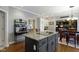 Kitchen with an island and bar seating, flowing into a dining area with ample natural light at 14215 Stacey St, Carmel, IN 46033