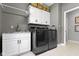 Laundry room with washer, dryer, sink, granite countertop, and ample cabinet space at 14215 Stacey St, Carmel, IN 46033