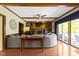 Bright living room with a fireplace, built-in shelving, ceiling fan, and large windows at 14215 Stacey St, Carmel, IN 46033