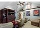 Cozy living room featuring a large entertainment center, ceiling fan, and stylish décor at 14215 Stacey St, Carmel, IN 46033