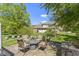 Stone patio includes outdoor seating around a fire pit and lush landscaping at 14215 Stacey St, Carmel, IN 46033