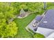 Aerial view of gray deck with outdoor furniture adjacent to a well-maintained lawn and partial views of the house at 14809 Senator Way, Carmel, IN 46032