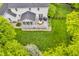 Aerial view of the house featuring a gray deck with outdoor furniture and lush green grass in the fenced yard at 14809 Senator Way, Carmel, IN 46032