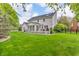 Expansive backyard featuring lush green grass, a patio, and mature trees that offer shade and privacy at 14809 Senator Way, Carmel, IN 46032