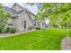 Well-maintained backyard featuring lush green grass, mature trees, and a charming patio area for outdoor relaxation at 14809 Senator Way, Carmel, IN 46032