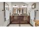 Bathroom featuring double sink vanity, decorative mirrors, towels, and modern fixtures for a luxurious feel at 14809 Senator Way, Carmel, IN 46032