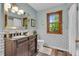 Bathroom showcasing subway tile, a wood vanity, a window, and a toilet at 14809 Senator Way, Carmel, IN 46032