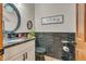 Stylish half bathroom with elegant black fixtures, granite countertop and decorative mirror at 14809 Senator Way, Carmel, IN 46032
