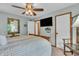 Bedroom featuring a decorative mirror, ceiling fan, mounted TV and access to the bathroom at 14809 Senator Way, Carmel, IN 46032