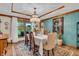 Stylish dining room featuring a large window, elegant chandelier, and decorative artwork for memorable dining at 14809 Senator Way, Carmel, IN 46032