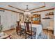 Elegant dining room with a chandelier, wooden table, and decorative accents for a sophisticated entertaining space at 14809 Senator Way, Carmel, IN 46032