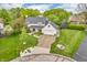 Charming two-story home with manicured lawn, mature trees, and an inviting front porch, creating a welcoming curb appeal at 14809 Senator Way, Carmel, IN 46032