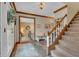 Bright foyer with wood floors, staircase, and views into adjacent rooms, creating a welcoming first impression at 14809 Senator Way, Carmel, IN 46032