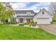 Charming two-story home with a manicured lawn and welcoming front porch adorned with patriotic decor at 14809 Senator Way, Carmel, IN 46032