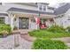 Charming front porch with cozy seating, decorative wreaths, and lush landscaping creating a welcoming entrance at 14809 Senator Way, Carmel, IN 46032