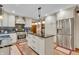 Open kitchen with a center island, stainless steel appliances, and custom cabinets at 14809 Senator Way, Carmel, IN 46032