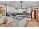 Modern kitchen with white cabinets, black countertops, and stainless steel appliances at 14809 Senator Way, Carmel, IN 46032