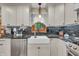 Bright kitchen featuring white cabinets, stainless steel dishwasher, and undermount sink at 14809 Senator Way, Carmel, IN 46032