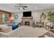 Inviting living room with brick fireplace, large TV, ceiling fan, and comfortable seating for relaxation at 14809 Senator Way, Carmel, IN 46032