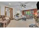 Comfortable living room with two sofas, brick fireplace, ceiling fan, and view into adjoining spaces at 14809 Senator Way, Carmel, IN 46032
