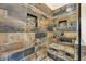 Close-up of the walk-in shower with stone-style tiles, built-in shelves, and a corner bench at 14809 Senator Way, Carmel, IN 46032